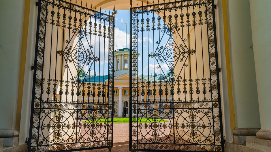Iron gate hung between two posts beside a path