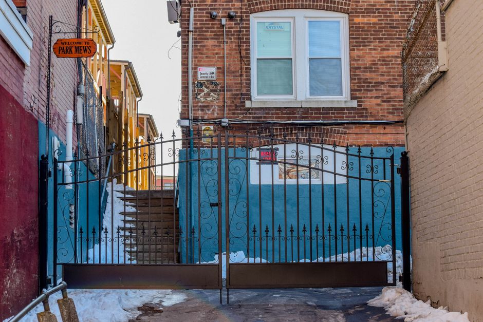 Black iron gate closed across a walkway