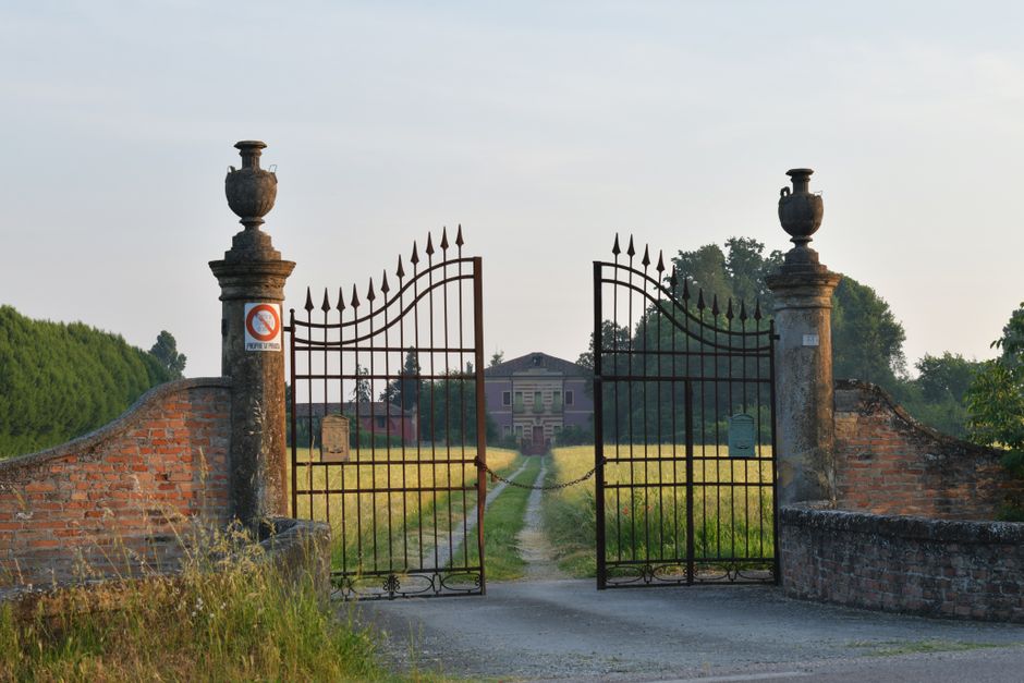 Decorative metal gate opening onto a courtyard