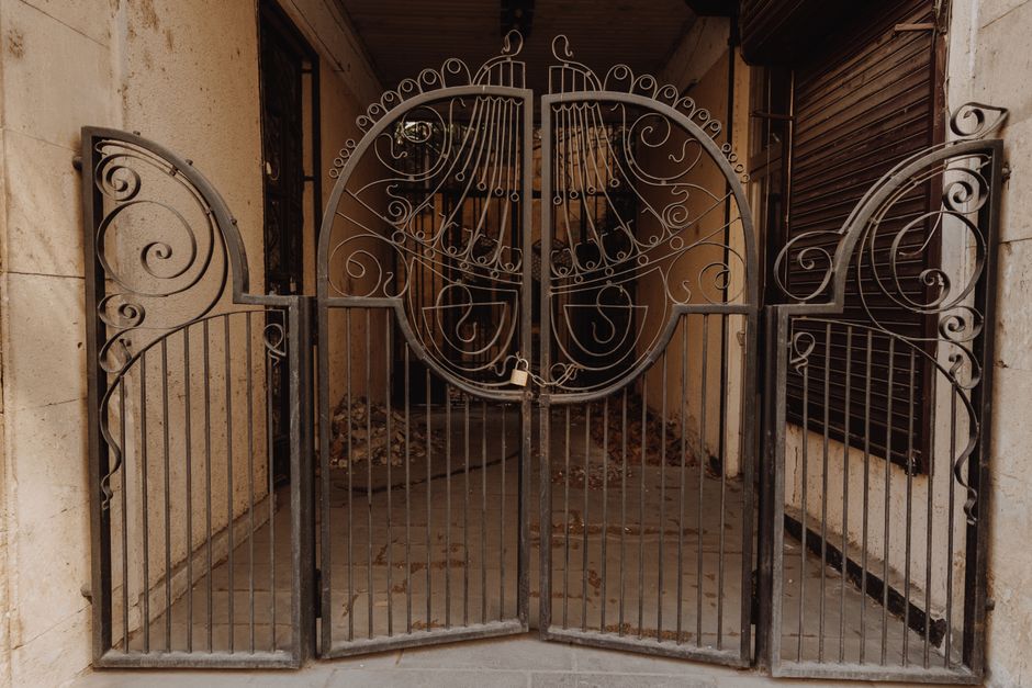 Painted iron gate set in a garden wall